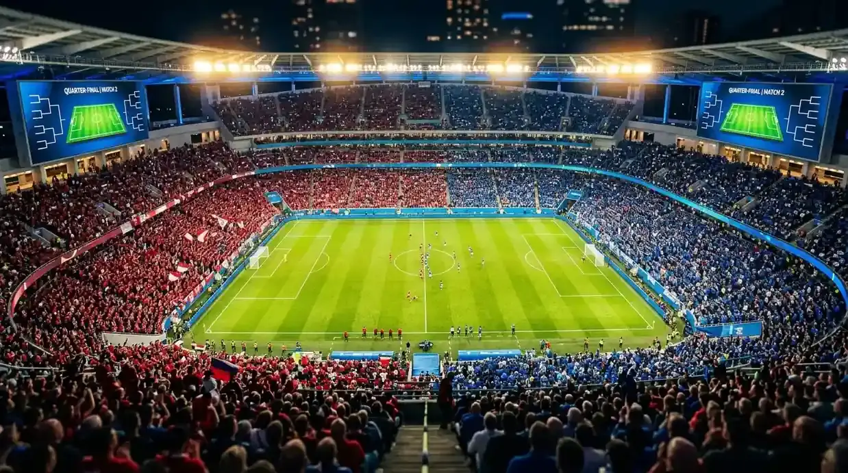 Veduta aerea di uno stadio moderno americano di sera, campo illuminato, tabellone luminoso che proietta due bandiere avversarie prima di un quarto di finale